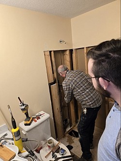 Plumber and Son installing new taps